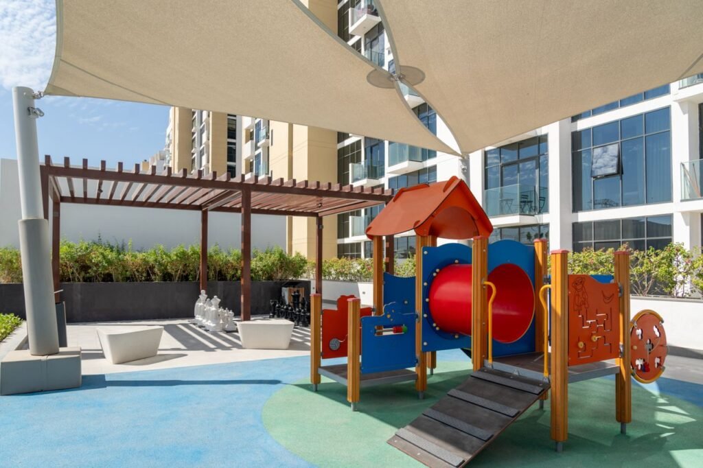 Modern playground equipment set in a Dubai residential outdoor space.